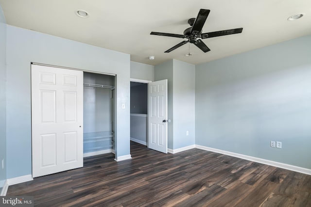 unfurnished bedroom featuring ceiling fan, a closet, and dark wood-type flooring