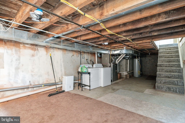 basement with water heater and washing machine and clothes dryer