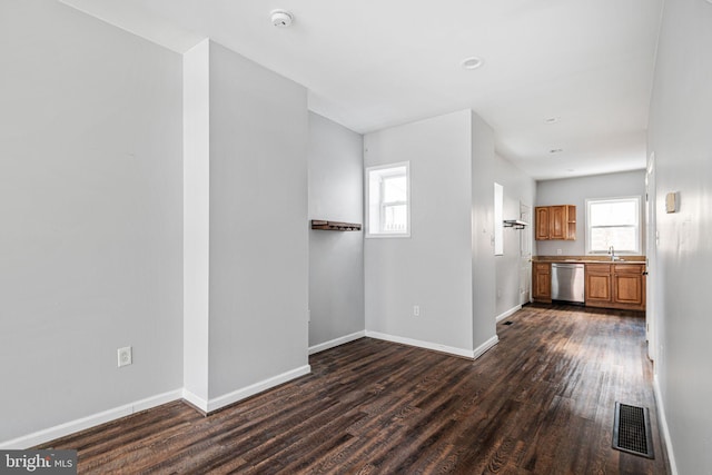 unfurnished living room featuring dark hardwood / wood-style floors and sink