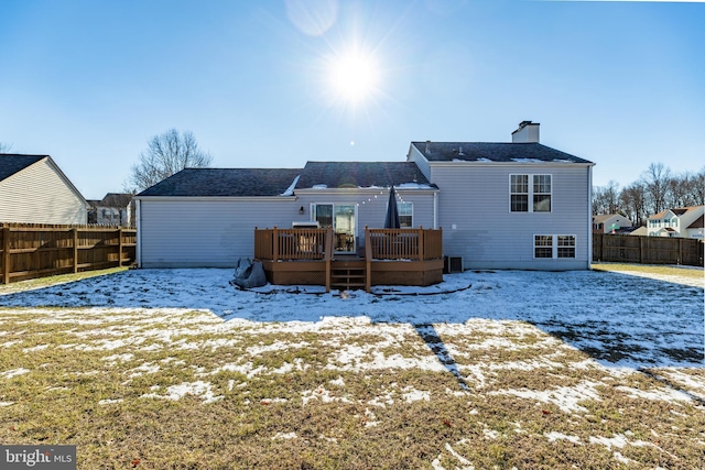 snow covered property featuring a wooden deck