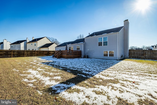 snow covered rear of property featuring a wooden deck