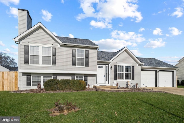 split level home featuring a front lawn and a garage