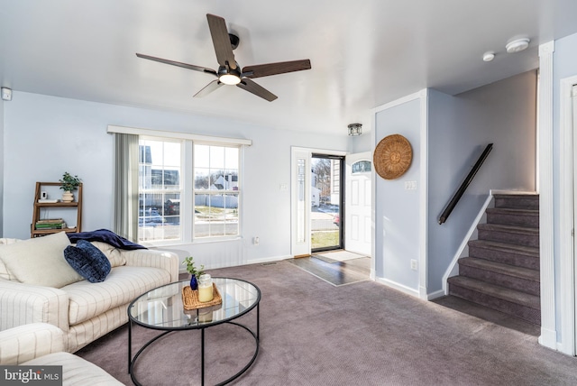 carpeted living room with ceiling fan