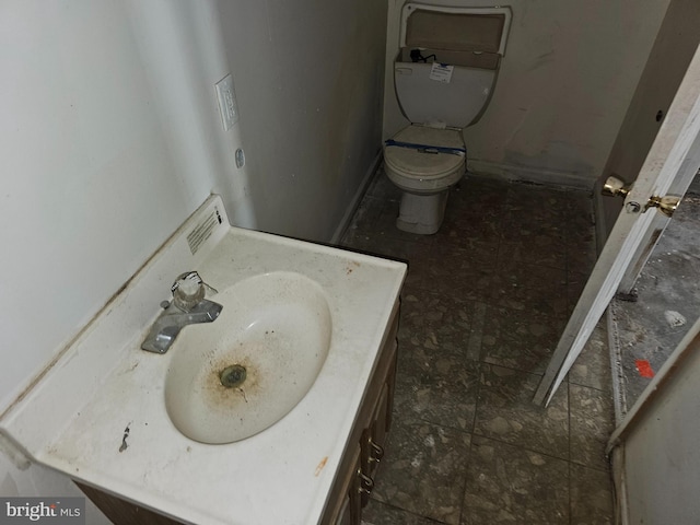 bathroom featuring vanity and toilet