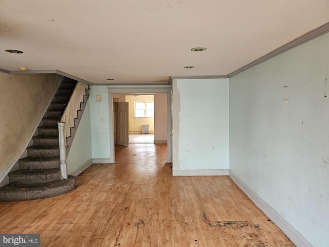 unfurnished room featuring light wood-type flooring and ornamental molding