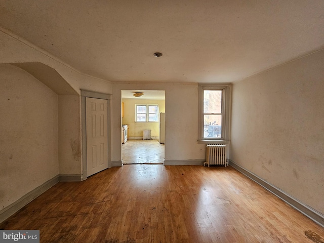 spare room with light hardwood / wood-style floors and radiator