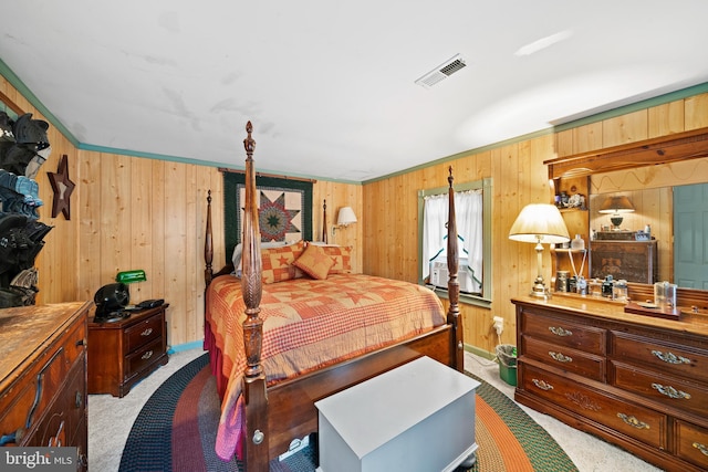 bedroom with light carpet and wooden walls