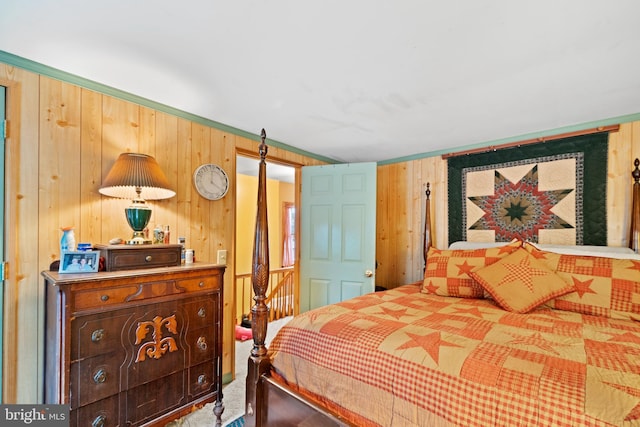 bedroom featuring wood walls