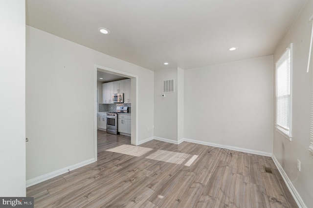 spare room featuring light hardwood / wood-style flooring