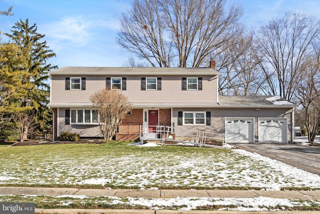 view of front facade with a garage and a yard