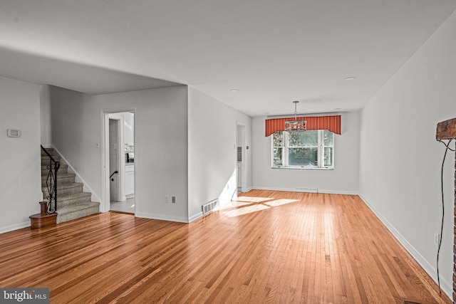 unfurnished living room with hardwood / wood-style flooring