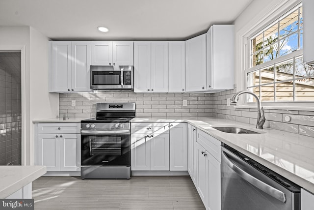 kitchen with white cabinets, stainless steel appliances, and sink