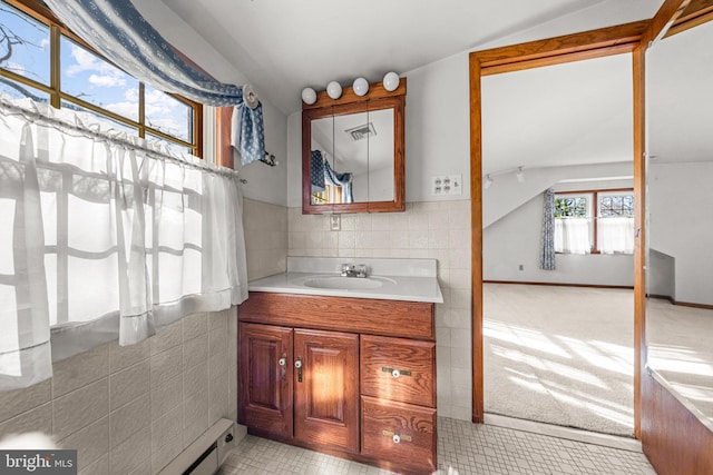 bathroom featuring vanity and vaulted ceiling