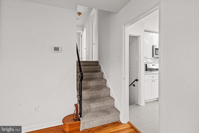 staircase with tile patterned floors