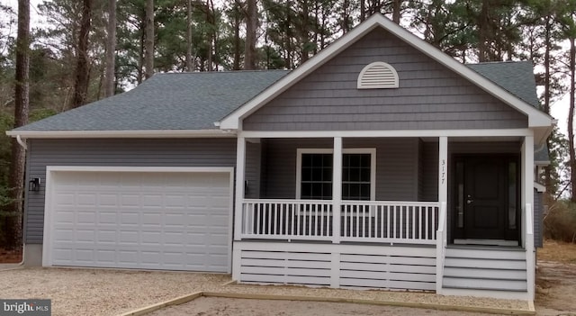 view of front of home featuring covered porch and a garage