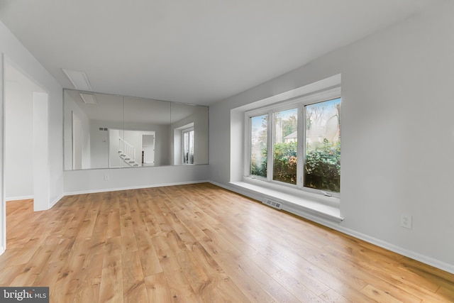 unfurnished room with light wood-type flooring