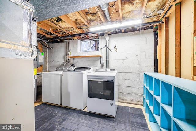 clothes washing area with washing machine and dryer