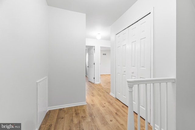 corridor with light wood-type flooring