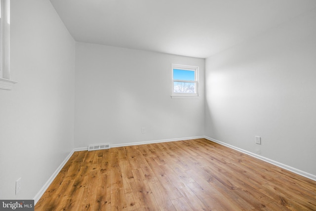 empty room with light hardwood / wood-style flooring