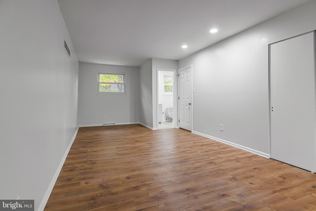 empty room with hardwood / wood-style flooring