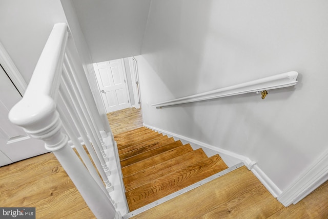 stairs with wood-type flooring