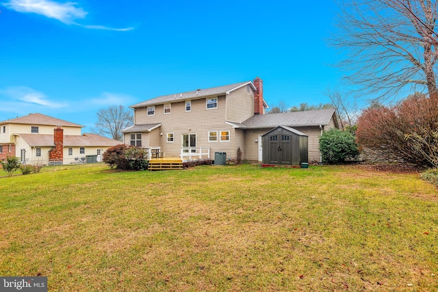 back of property with a yard, central air condition unit, a storage shed, and a wooden deck