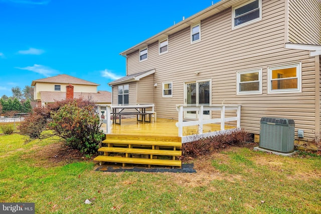 back of house with a lawn, a wooden deck, and cooling unit