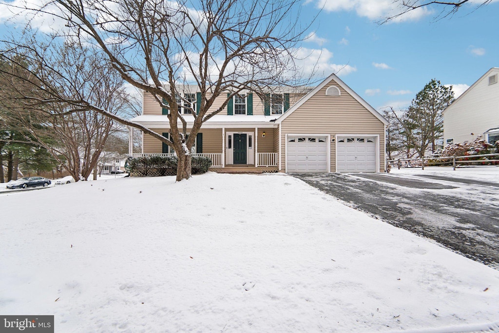 view of front property with covered porch and a garage