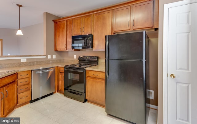 kitchen with black appliances, pendant lighting, and sink