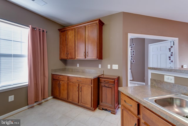 kitchen with light tile patterned floors and sink