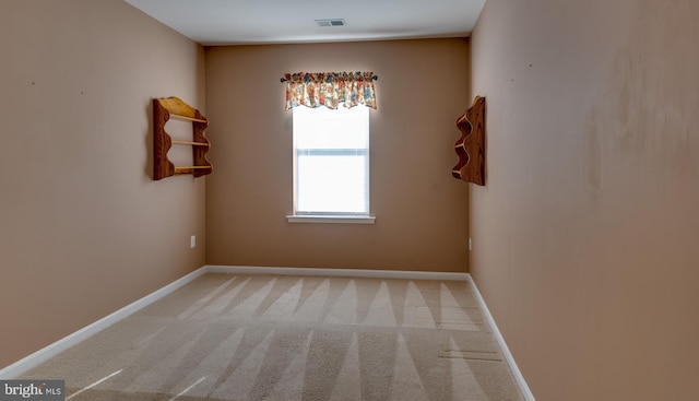 unfurnished room with light colored carpet