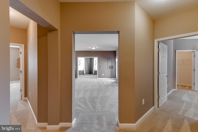 hallway with light colored carpet