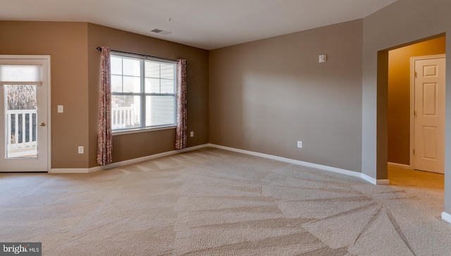 spare room with light carpet