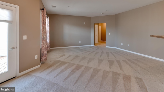 spare room with light colored carpet