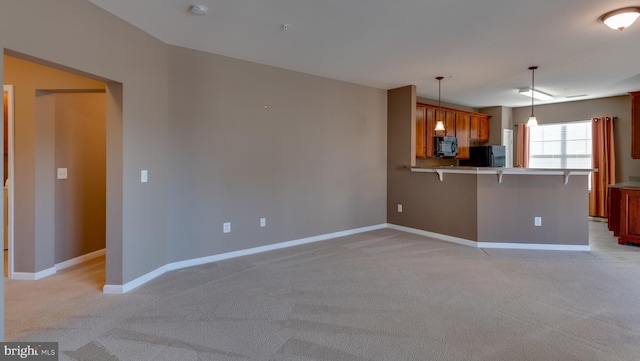 unfurnished living room featuring light carpet