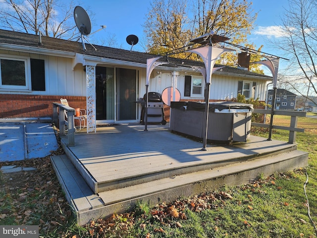 back of property featuring a wooden deck and a hot tub