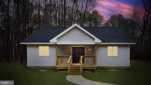 view of front facade featuring a shingled roof, crawl space, a yard, and a wooden deck