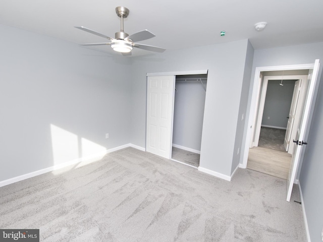 unfurnished bedroom featuring a ceiling fan, carpet, a closet, and baseboards