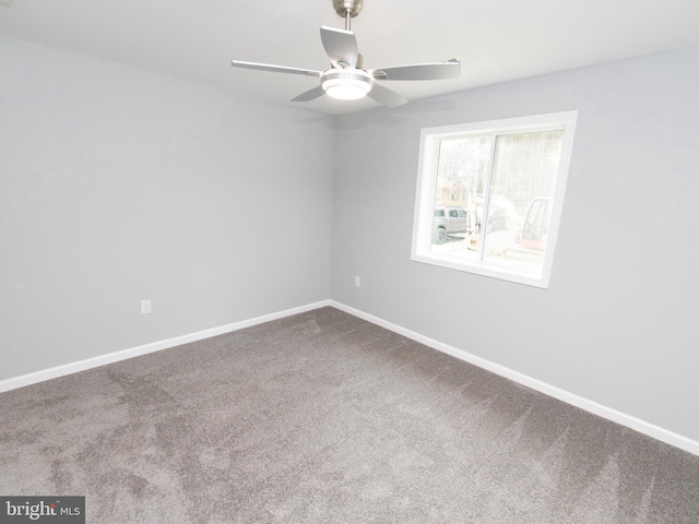 unfurnished room with carpet, baseboards, and a ceiling fan