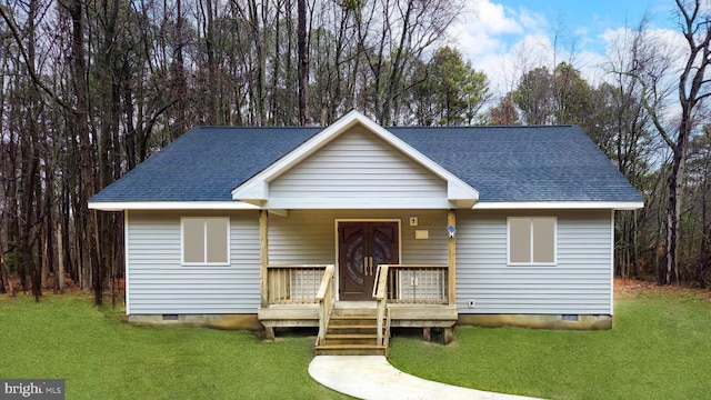 view of front facade with a shingled roof, crawl space, covered porch, and a front lawn