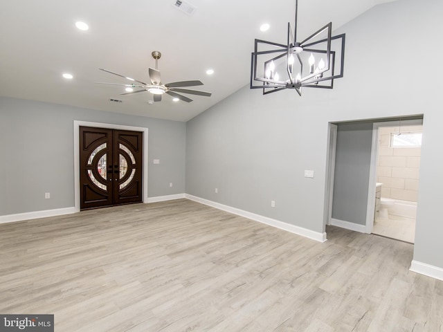 interior space featuring visible vents, vaulted ceiling, light wood-style flooring, and baseboards