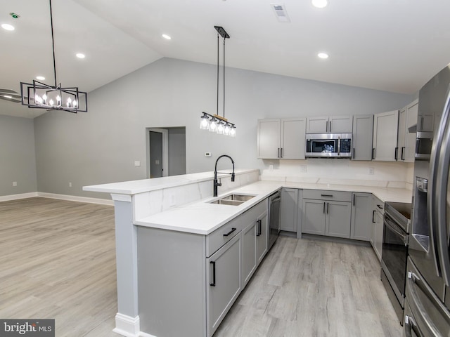 kitchen with visible vents, light wood-style flooring, stainless steel appliances, gray cabinetry, and a sink