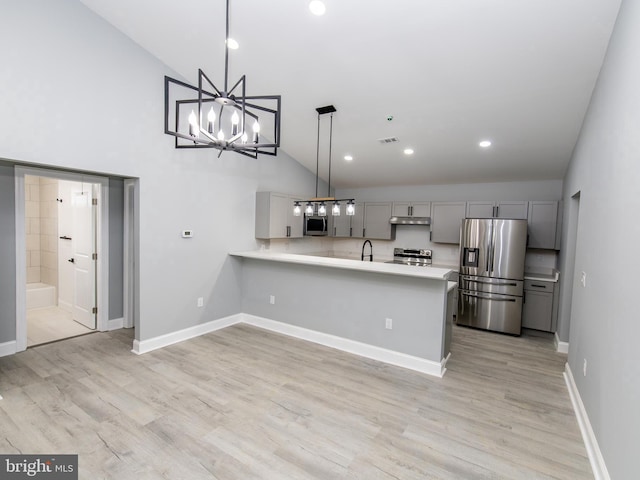 kitchen featuring light wood-style floors, gray cabinets, stainless steel appliances, light countertops, and under cabinet range hood