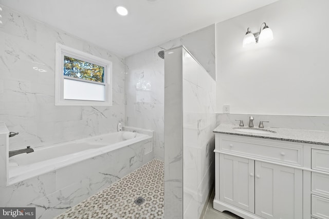 bathroom with vanity and independent shower and bath