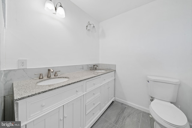 bathroom featuring tile patterned floors, vanity, and toilet