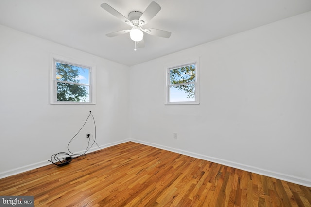 unfurnished room featuring hardwood / wood-style floors and ceiling fan