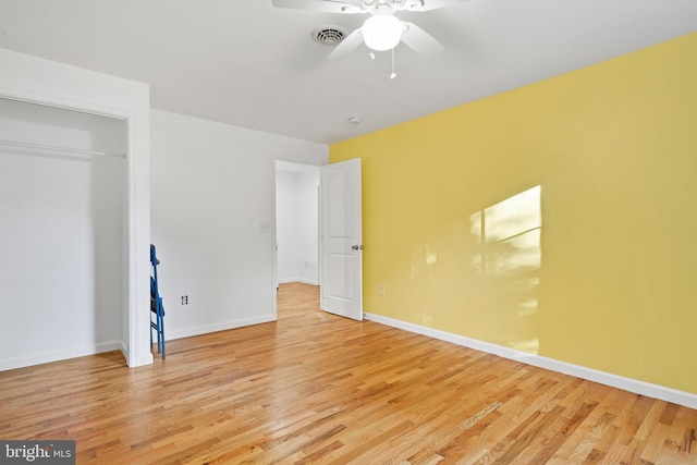 unfurnished bedroom with a closet, light hardwood / wood-style flooring, and ceiling fan