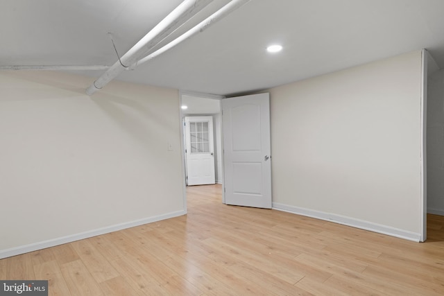 basement with light hardwood / wood-style flooring