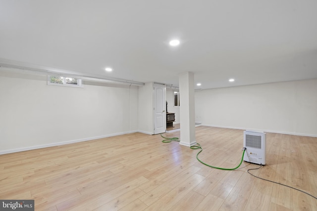 basement with light hardwood / wood-style floors