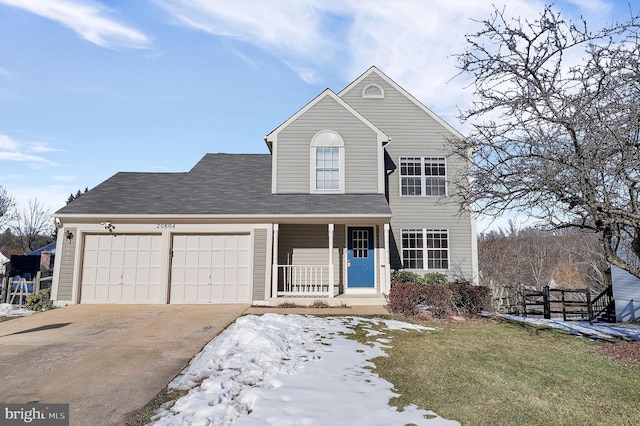 view of front property featuring a garage, a front lawn, and a porch